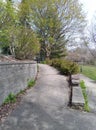 Slightly unkempt garden path and wall dried leaves stone