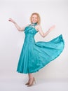 Slim airy girl in flying blue evening dress on white background in Studio Royalty Free Stock Photo