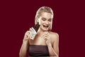 Slim appealing model feeling cheerful while eating chocolate Royalty Free Stock Photo
