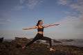 Slim Asian woman practicing Virabhadrasana II, Warrior II Pose. Yoga retreat. Healthcare concept. Balance and concentration. Zen Royalty Free Stock Photo