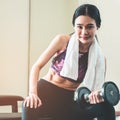 Slim asian woman is working out with dumbbell Royalty Free Stock Photo