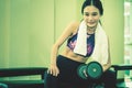 Slim asian woman is working out with dumbbell Royalty Free Stock Photo