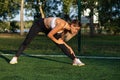 Slim athletic woman warms up before workout