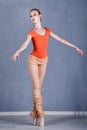 Slim ballerina rehearsing dance. On tiptoe.