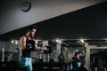 Slim bearded young man with muscular wiry body wearing sportswear lifting barbell Royalty Free Stock Photo