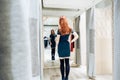 Young beautiful girl trying on new green dress in the fitting room in boutique Royalty Free Stock Photo