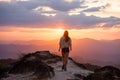 Slim beautiful girl walks mountains at sunset Royalty Free Stock Photo