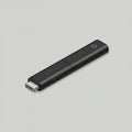 Slim black electronic device resembling a USB-C flash drive or wireless adapter. Royalty Free Stock Photo