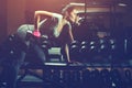 Slim, bodybuilder girl, lifts heavy dumbbell standing in front of the mirror while training in the gym. Royalty Free Stock Photo