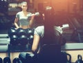 Slim, bodybuilder girl, lifts heavy dumbbell standing in front of the mirror while training in the gym. Royalty Free Stock Photo