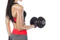 Slim bodybuilder girl lifts heavy dumbbell while training in the gym.