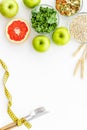 Measuring tape, apples, oat meal and grapefruit for loosing weight on white background top view mockup Royalty Free Stock Photo