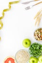 Measuring tape, apples, oat meal and grapefruit for loosing weight on white background top view mockup Royalty Free Stock Photo