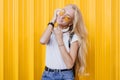 Slim dreamy woman with long shiny hair enjoying good day. Portrait of lovely tanned girl in white t-