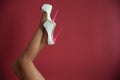 Slim female legs in high heel shoes raised up on a red background Royalty Free Stock Photo