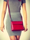 Slim girl in gray skirt with red handbag Royalty Free Stock Photo
