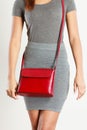 Slim girl in gray skirt with red handbag Royalty Free Stock Photo