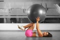 Slim girl laying with aerobic ball Royalty Free Stock Photo