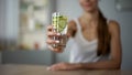 Slim girl offers beverage with vegetables for healthy skin, body water balance