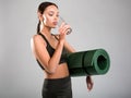 Slim girl quenching thirst after fitness classes Royalty Free Stock Photo