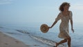 Slim girl running ocean water holding hat summer day. Closeup woman legs walking Royalty Free Stock Photo