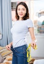 Slim glad young woman measuring waist with measuring tape