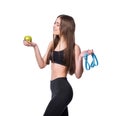 Slim and healthy young woman holding measure tape and apple isolated on white background. Weight loss and diet concept. Royalty Free Stock Photo