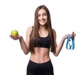 Slim and healthy young woman holding measure tape and apple isolated on white background. Weight loss and diet concept. Royalty Free Stock Photo