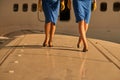 Slim legs of pretty stewardesses walking on the wing