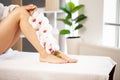 Slim long woman legs with pink flowers. Royalty Free Stock Photo