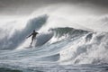 Slim male surfing on foamy high waves splashing in the sea