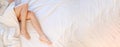 Slim, perfect and beautiful crossed woman& x27;s legs on bed. Cropped image erotic Royalty Free Stock Photo