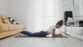 Slim sporty african american woman practicing yoga on a mat. Woman in activewear perform plank position exercise on mat Royalty Free Stock Photo