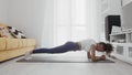 Slim sporty african american woman practicing yoga on a mat. Woman in activewear perform plank position exercise on mat Royalty Free Stock Photo