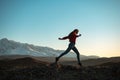 Slim sporty girl walks at sunset in mountains Royalty Free Stock Photo