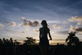 Slim stylish girl enjoying sky views in evening. Outdoor photo of magnificent lady looking at clouds