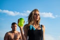 Slim trainer of fitness woman with protein shaker. Smiling young female and personal couple coach. Man and girl with