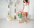 Slim unidentified young mother in a white dress Royalty Free Stock Photo