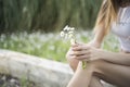 Slim woman holding a chamomile Royalty Free Stock Photo