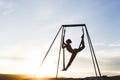 Woman practicing fly dance yoga poses in hammock outdoors at sunset Royalty Free Stock Photo