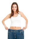 Slim woman pulling oversized jeans