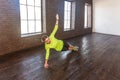 Slim woman in side plank pose at yoga class, Vasisthasana exercise.