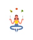 Slim woman sitting in meditation with a fork and knife in her hands and healthy food. Avocado, broccoli, tomato. Healthy lifestyle