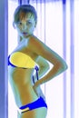 Slim woman in solarium getting sun tan Royalty Free Stock Photo