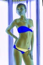 Slim woman in solarium getting sun tan Royalty Free Stock Photo