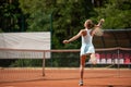 Slim woman is spending active time on court outdoor Royalty Free Stock Photo