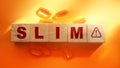 Slim word on a wooden blocks and oil capsules on a orange background. . Healthy living beauty concept Royalty Free Stock Photo