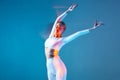 Slim young girl dancing ballet with raised hands, stretching arms, exercising. Motion blur. Wellness, healthy lifestyle Royalty Free Stock Photo