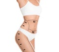 Slim young woman with marks on body for cosmetic surgery operation against background, closeup Royalty Free Stock Photo