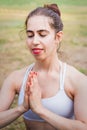 Slim young woman practicing yoga in nature, meditating